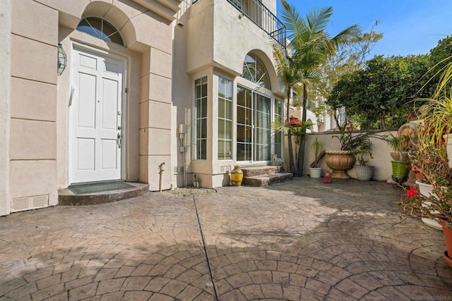 doorway to property with a patio area