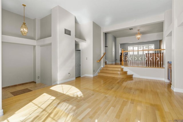 foyer with an inviting chandelier and hardwood / wood-style floors