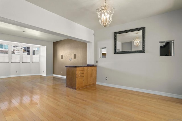 interior space with an inviting chandelier and light hardwood / wood-style floors