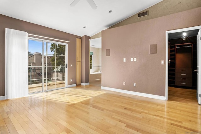 spare room with vaulted ceiling, ceiling fan, and light hardwood / wood-style floors