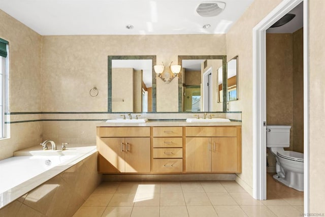 bathroom featuring vanity, a tub to relax in, tile patterned floors, and toilet