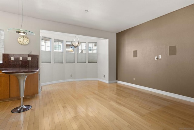 unfurnished dining area featuring light wood-type flooring