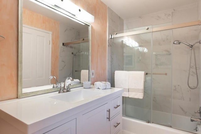 bathroom with vanity and bath / shower combo with glass door