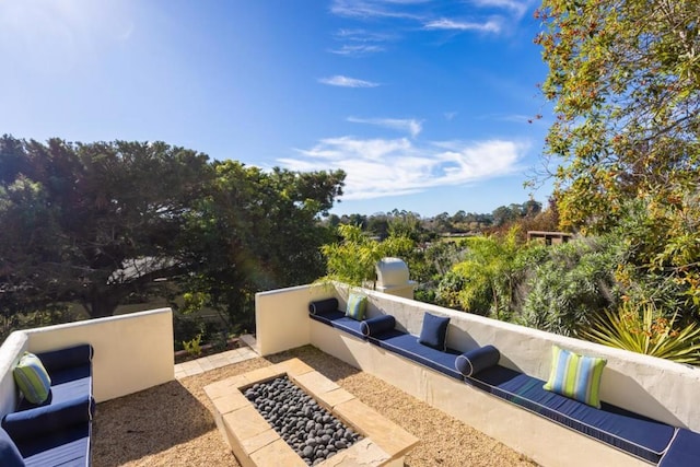 view of patio / terrace with an outdoor fire pit