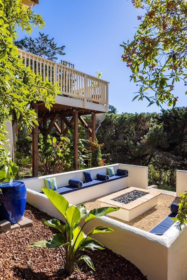 view of patio / terrace featuring a fire pit and a deck