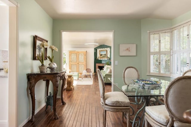 dining space with dark hardwood / wood-style flooring