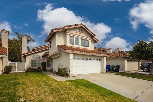 mediterranean / spanish home with a garage and a front yard