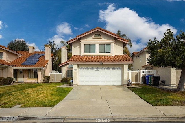 view of front of house with a garage, a front lawn, and solar panels