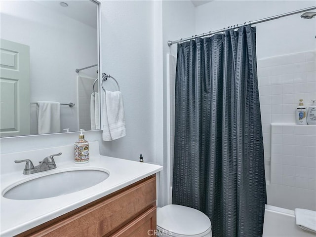 full bathroom featuring vanity, shower / tub combo, and toilet