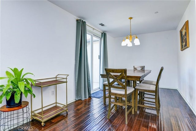 dining room featuring dark wood-type flooring and a notable chandelier