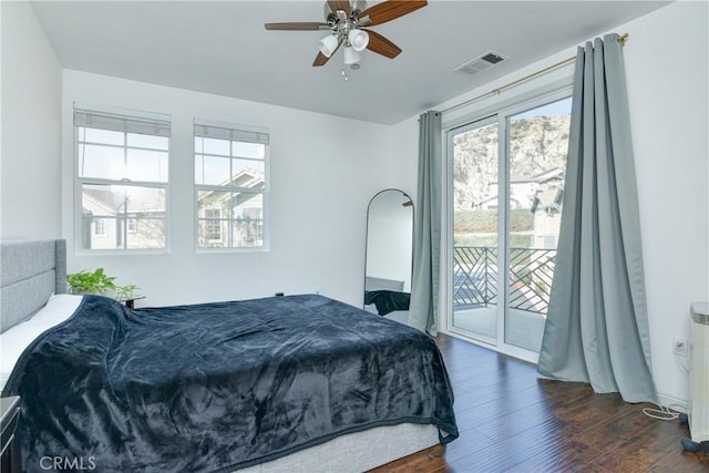 bedroom featuring access to outside, dark hardwood / wood-style floors, and ceiling fan