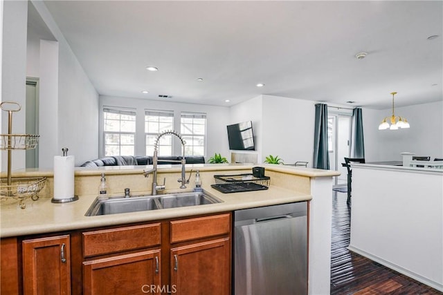 kitchen with pendant lighting, stainless steel dishwasher, dark wood-type flooring, and sink