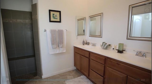 bathroom featuring vanity and a tile shower