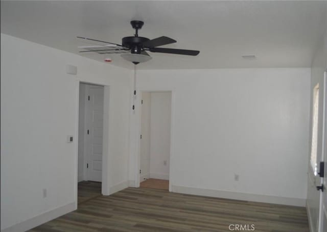 spare room featuring dark hardwood / wood-style floors and ceiling fan