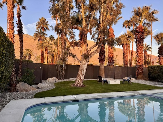 view of pool featuring a mountain view and a lawn