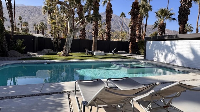 view of pool with a mountain view and a patio area