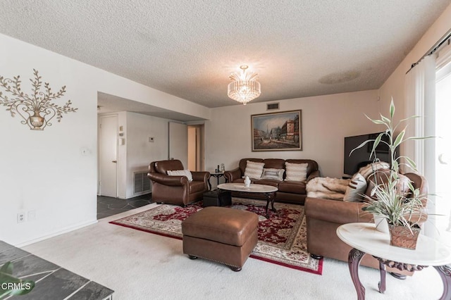 living room with an inviting chandelier, carpet, and a textured ceiling