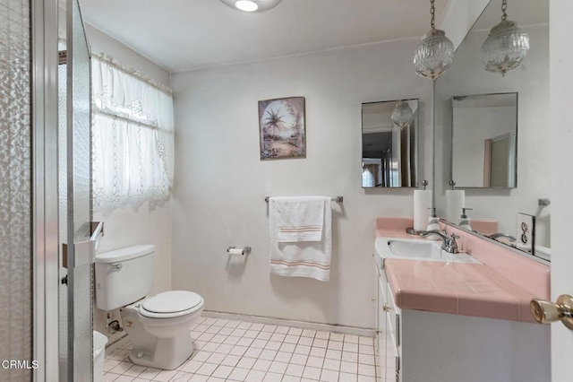 bathroom with vanity, toilet, and tile patterned flooring