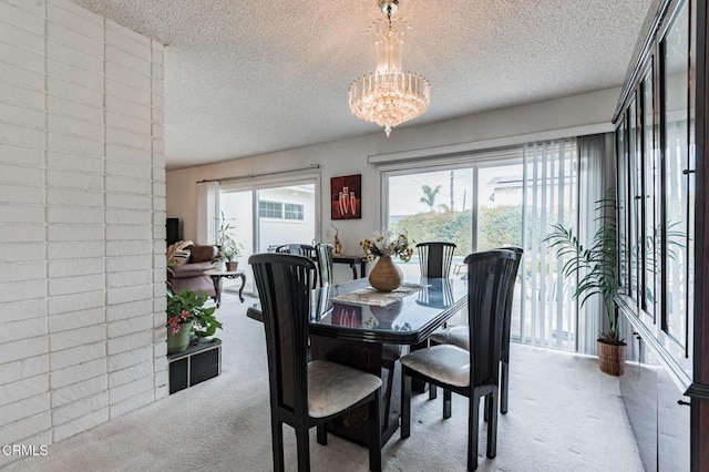 dining space with light carpet, a textured ceiling, and a chandelier