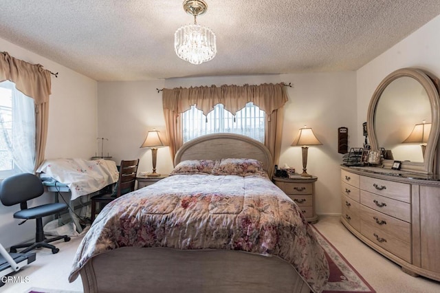 bedroom with a chandelier, carpet floors, and a textured ceiling