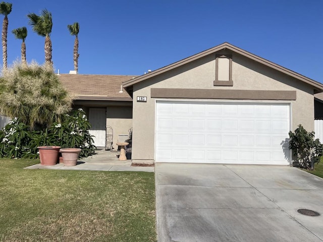 single story home featuring a garage and a front yard