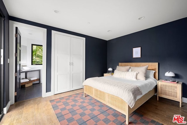 bedroom featuring wood-type flooring and a closet