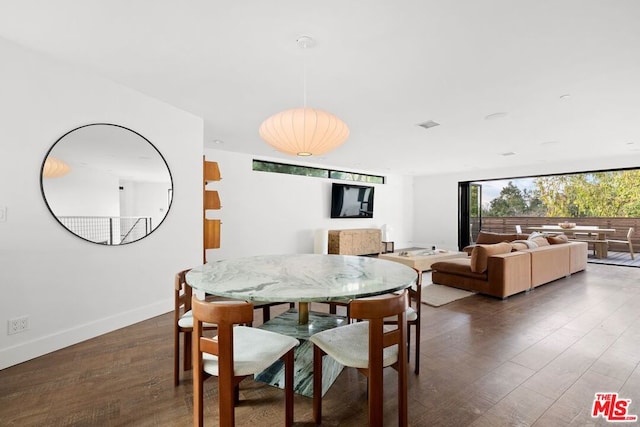 dining area featuring dark wood-type flooring