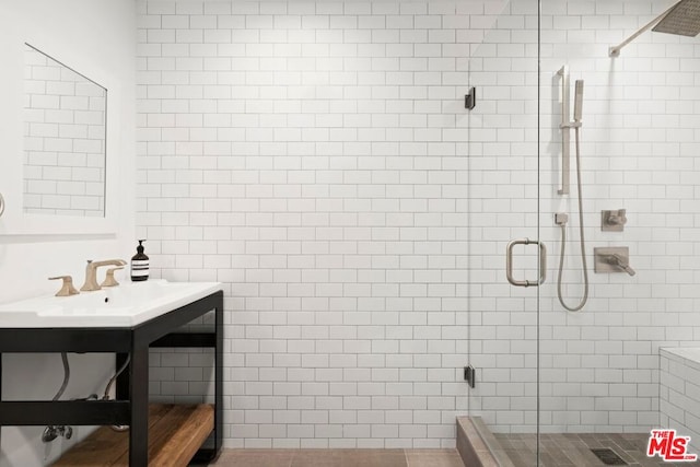 bathroom featuring sink and an enclosed shower