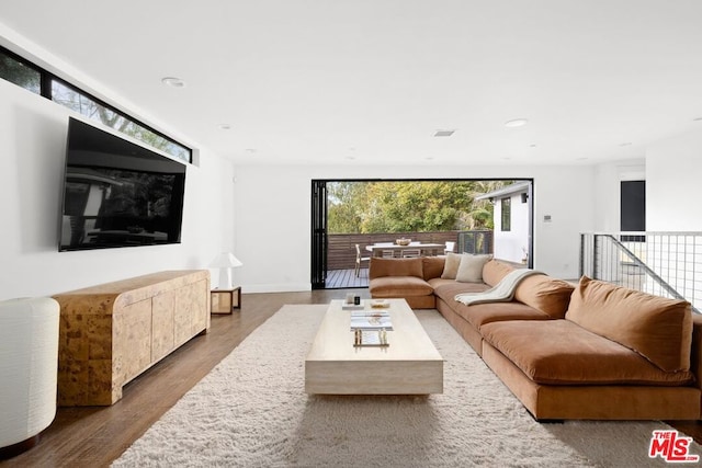 living room with dark hardwood / wood-style flooring