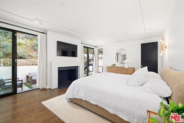 bedroom featuring dark wood-type flooring and access to outside