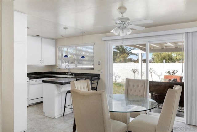 dining space featuring sink, a healthy amount of sunlight, and ceiling fan