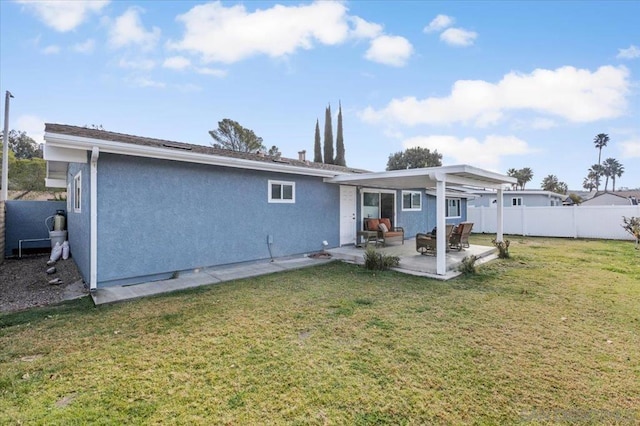 rear view of property featuring a yard and a patio