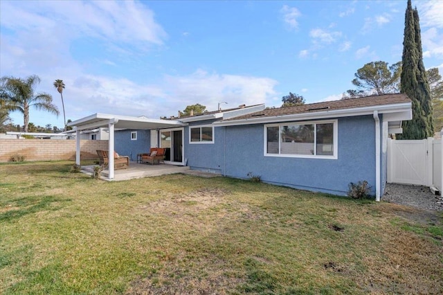 back of house with a yard and a patio area