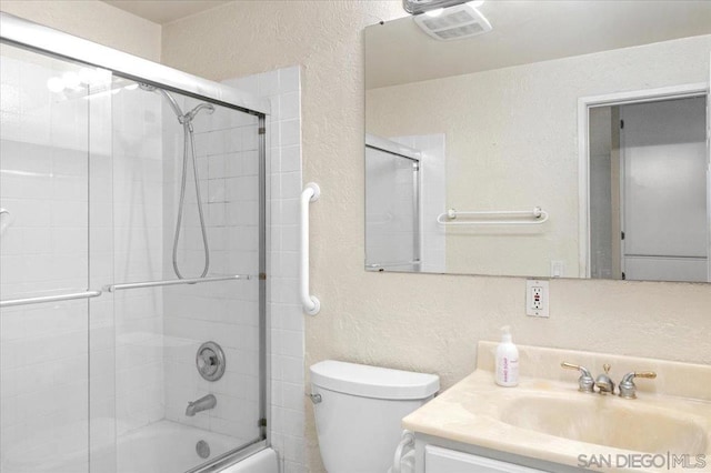 full bathroom featuring vanity, toilet, and combined bath / shower with glass door