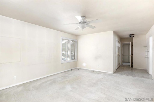 spare room with light carpet and ceiling fan