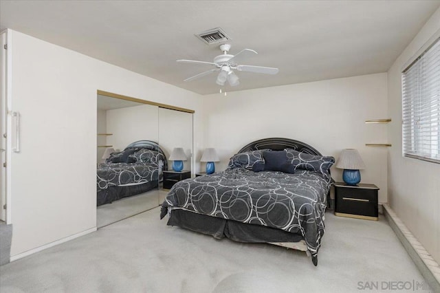 bedroom with carpet flooring, ceiling fan, and a closet