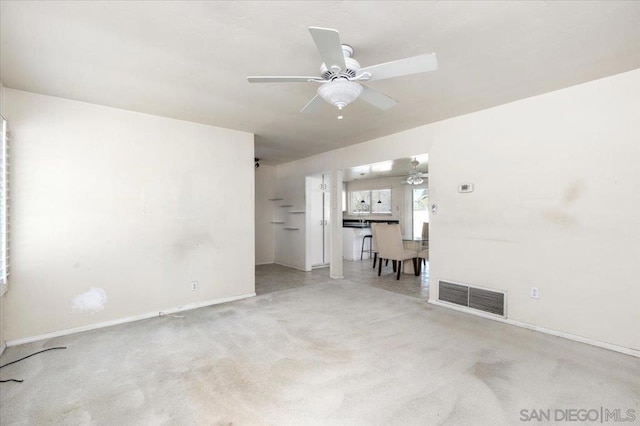 carpeted empty room featuring ceiling fan