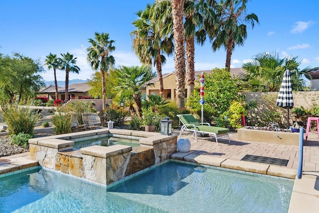 view of pool with a patio area and an in ground hot tub