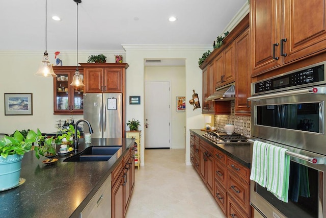 kitchen featuring ornamental molding, stainless steel appliances, decorative light fixtures, and sink