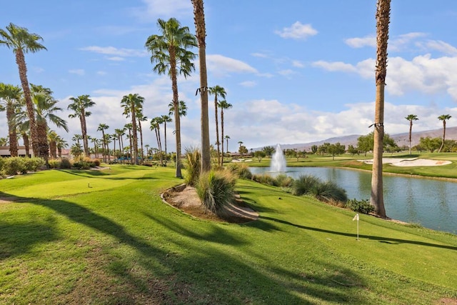 view of community with a lawn and a water view