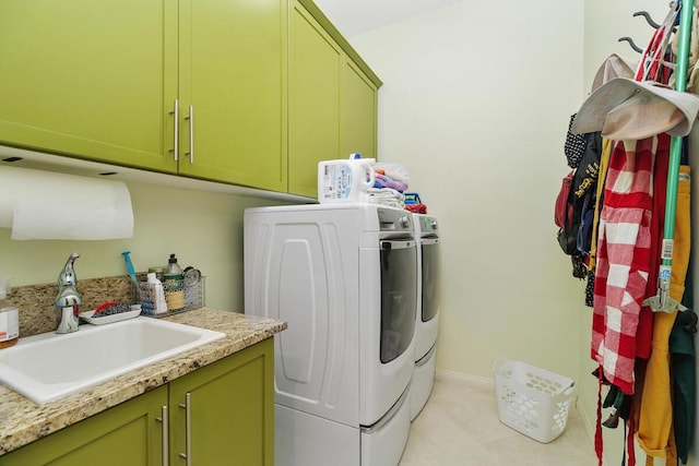 laundry room featuring sink, washing machine and dryer, and cabinets