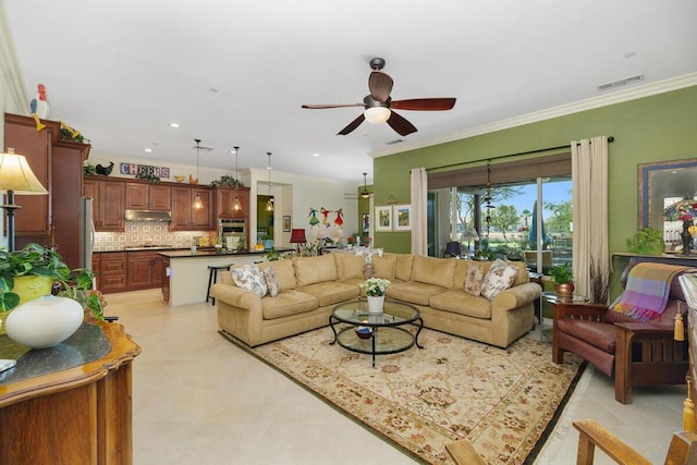 living room with ornamental molding and ceiling fan