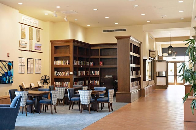 dining space with a towering ceiling