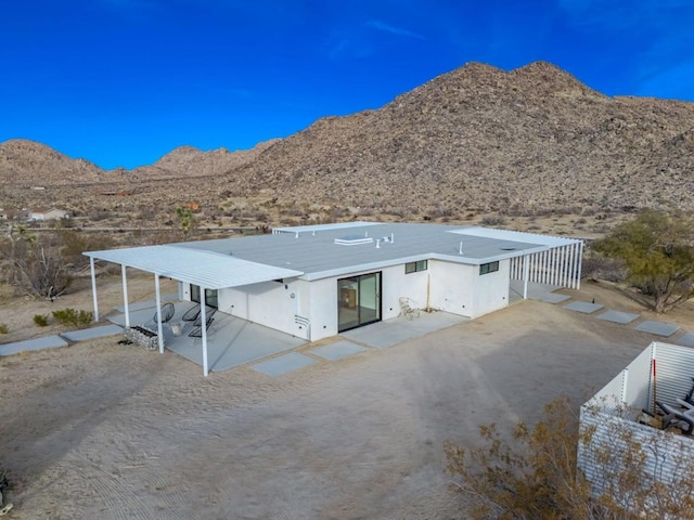 back of property with a mountain view