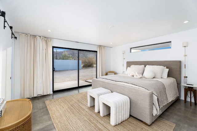 bedroom with a barn door and access to exterior