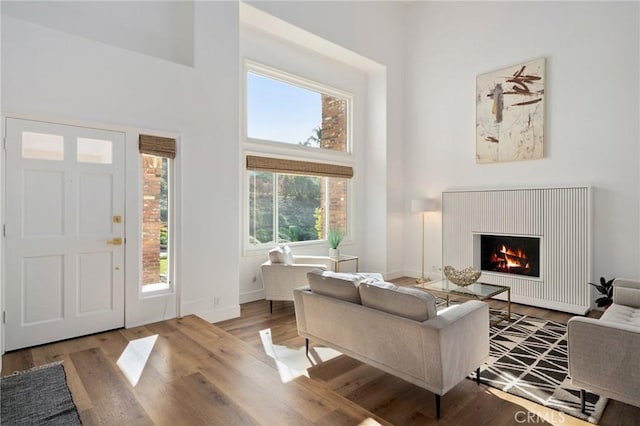 interior space with a towering ceiling and hardwood / wood-style floors