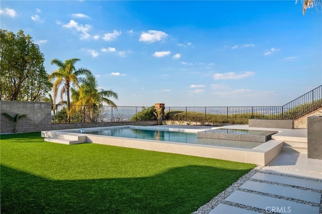 view of pool featuring an in ground hot tub and a yard