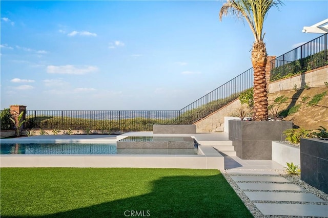 view of swimming pool featuring a lawn