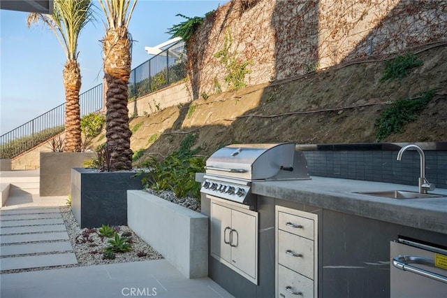 view of patio / terrace with sink, grilling area, and an outdoor kitchen