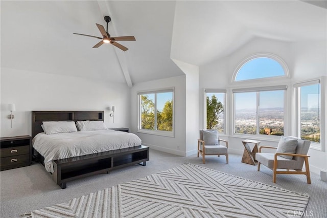 bedroom with multiple windows, light colored carpet, high vaulted ceiling, and ceiling fan